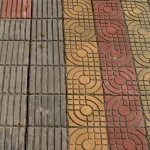 Sidewalk tiles:  Glazed snail shells, and  blind stripes - PuDong, Shanghai